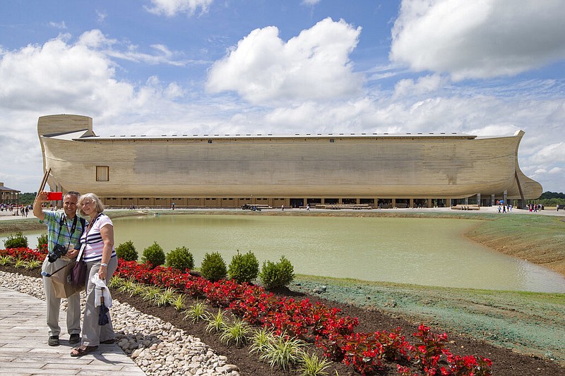 Visitors take a selfie at the Ark Encounter theme park during a media preview day in Williamstown, Ky., in this July 5, 2016, file photo. In the background is a replica Noah's Ark that's more than 500 feet long. (AP/John Minchillo)