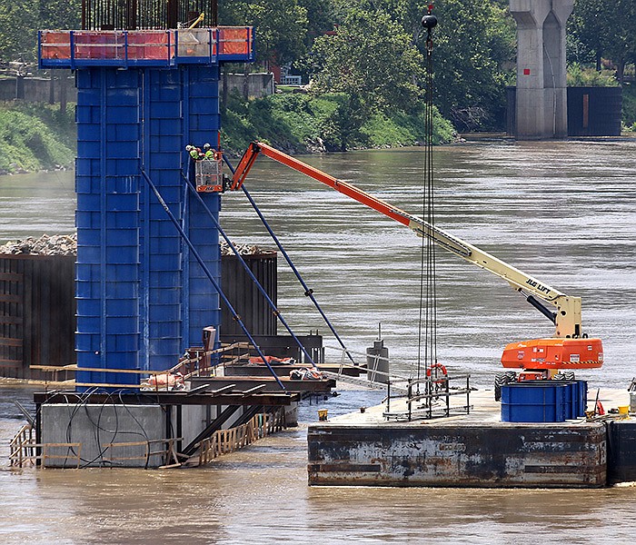Construction crews work Thursday on one of the new bridge pylons on the Arkansas River for the 30 Crossing project in Little Rock.
(Arkansas Democrat-Gazette/Thomas Metthe)