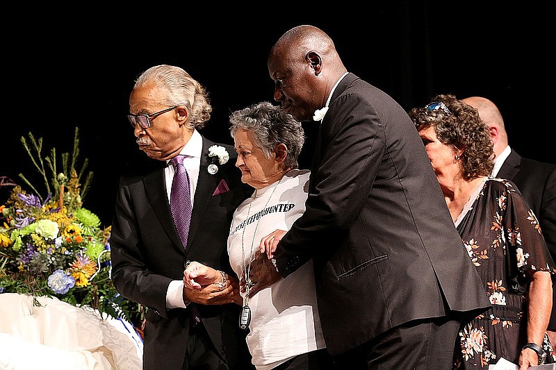 Rev. Al Sharpton (left) and attorney Benjamin Crump (right) escort Rebecca Payne to view her grandson’s casket during the funeral service for 17-year-old Hunter Brittain, on Tuesday, July 6, 2021, at the Beebe Schools Auditorium in Beebe. Brittain was shot by a Lonoke County Sheriff’s Deputy during a traffic stop on June 23. (Arkansas Democrat-Gazette/Thomas Metthe)