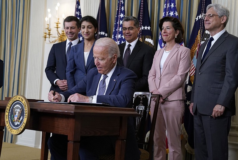 President Joe Biden signs an executive order on competition in the economy Friday at the White House. Joining him are (from left) Transportation Secretary Pete Buttigieg, Federal Trade Commission Chairman Lina Khan, Health and Human Services Secretary Xavier Becerra, Commerce Secretary Gina Raimondo and Attorney General Merrick Garland.
(AP/Evan Vucci)