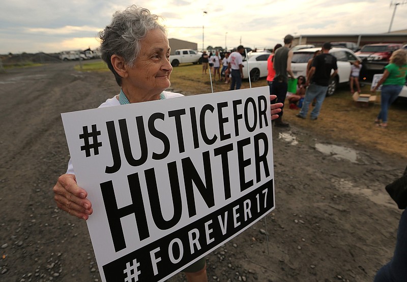 Rebecca Payne holds a "Justice for Hunter" sign outside the Lonoke County sheriff's office in Lonoke in this July 1, 2021, file photo. Payne was joining the nightly rally protesting the shooting death of her grandson, 17-year-old Hunter Brittain. (Arkansas Democrat-Gazette/Thomas Metthe)