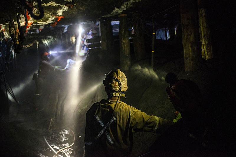 Lights from miners’ safety helmets illuminate the mine shaft during a media tour of the Sibanye-Stillwater Khuseleka platinum mine outside Rustenburg, South Africa, in 2019.
(Bloomberg (WPNS)/Waldo Swiegers)