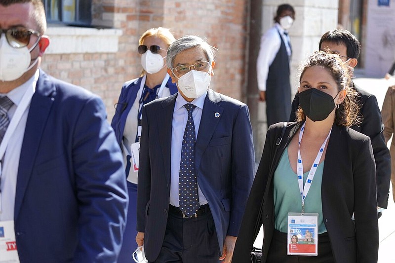 Haruhiko Kuroda (center), governor of the Bank of Japan, arrives Friday, July 9, 2021, for a G-20 meeting of economy and finance ministers and central bank governors in Venice, Italy. (AP/Luca Bruno)