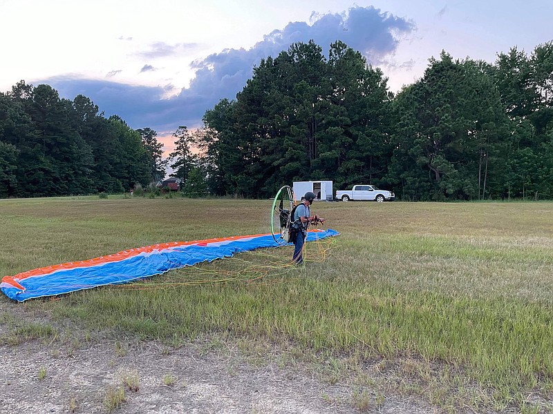 Don Guthrie prepares to take off into flight on his powered paraglider on Monday, July 5. He calls the process, which requires a running start before the motor and wind combine to life him into the air, “running into the skies.” (Courtesy of Johnathan Estes)