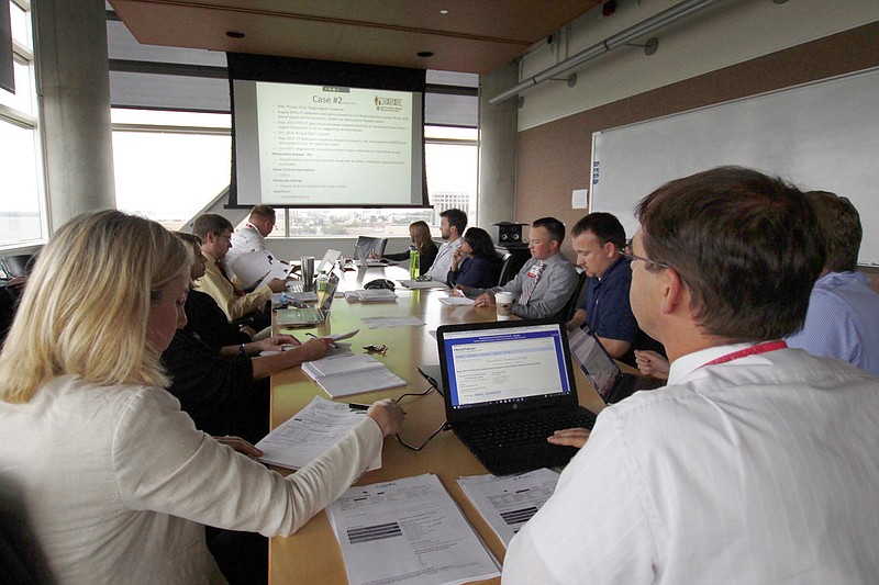 Doctors, pharmacists, geneticists and others meet to discuss how to best treat cancer patients at the University of Wisconsin Carbone Cancer Center in Madison, Wis., in this Aug. 17, 2017, file photo. (AP/Carrie Antlfinger)