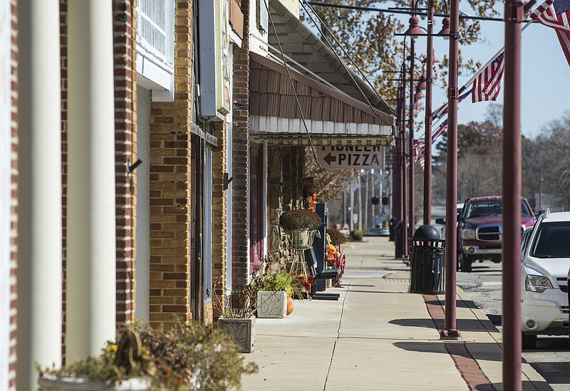 NWA Democrat-Gazette/BEN GOFF
Flags decorate lamp posts on Nov. 13, 2019, on West Main Street in Gentry.