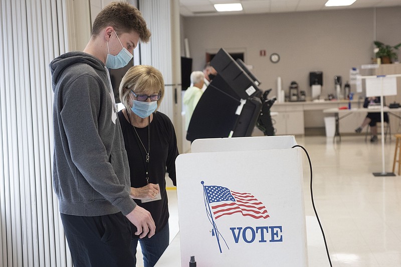 File photo -- Jan Turner of Fayetteville (left) votes with the assistance of poll worker Paulette Lilly Tuesday May 18, 2021 at Central United Methodist Church. (NWA Democrat-Gazette/J.T. Wampler)