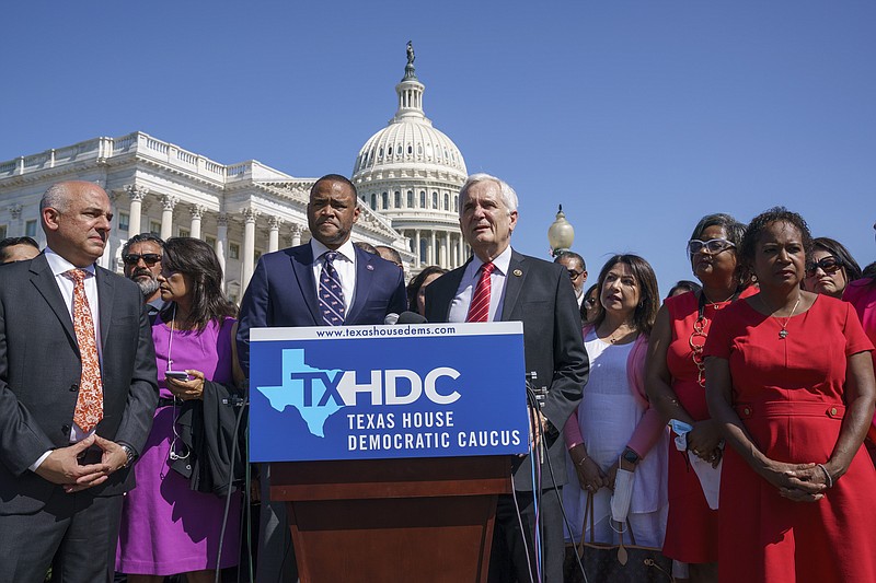 Rep. Marc Veasey, D-Texas, center left, and Rep. Lloyd Doggett, D-Texas, joined at left by Rep. Chris Turner, chairman of the Texas House Democratic Caucus, welcome Democratic members of the Texas legislature at a news conference at the Capitol in Washington, Tuesday, July 13, 2021. (AP/J. Scott Applewhite)