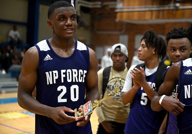 Derrian Ford accepts a trophy for MVP after his team, NP Force, won the Real Deal in the Rock 17U Championship game on Sunday, June 27, 2021. 
(Arkansas Democrat-Gazette/Stephen Swofford)