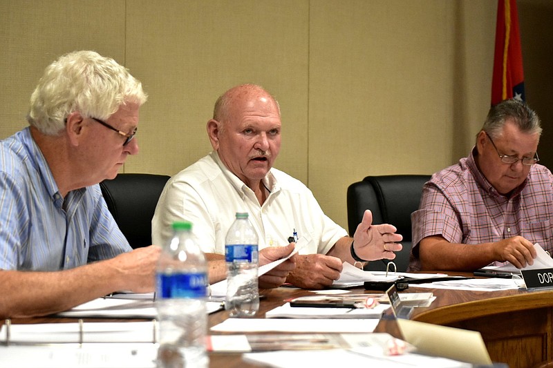 White Hall School District Superintendent Doug Dorris speaks Tuesday as board President Dr. Raymond Jones (left) and board member Scott Ray listen. 
(Pine Bluff Commercial/I.C. Murrell)