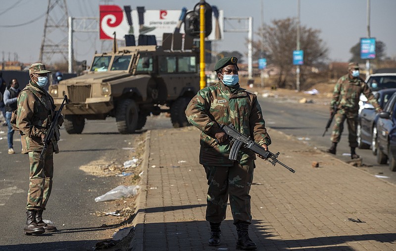 Soldiers patrol Wednesday outside a shopping mall in Vosloorus, South Africa. More photos at arkansasonline.com/715zuma/.
(AP/Themba Hadebe)
