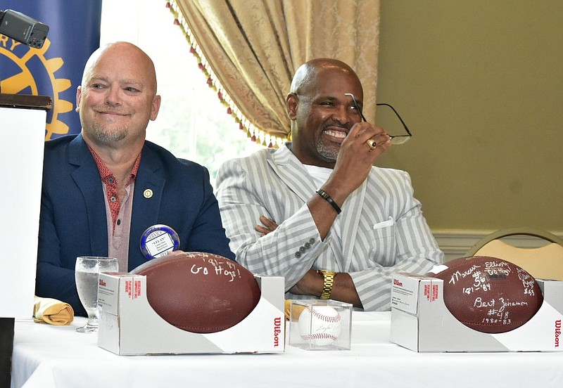 Doctor’s Orders Pharmacy owner Lelan Stice (left) and Little Rock radio personality Marcus Elliott listen to opening comments Thursday during the Rotary Club of West Pine Bluff’s luncheon at the Pine Bluff Country Club. 
(Pine Bluff Commercial/I.C. Murrell)