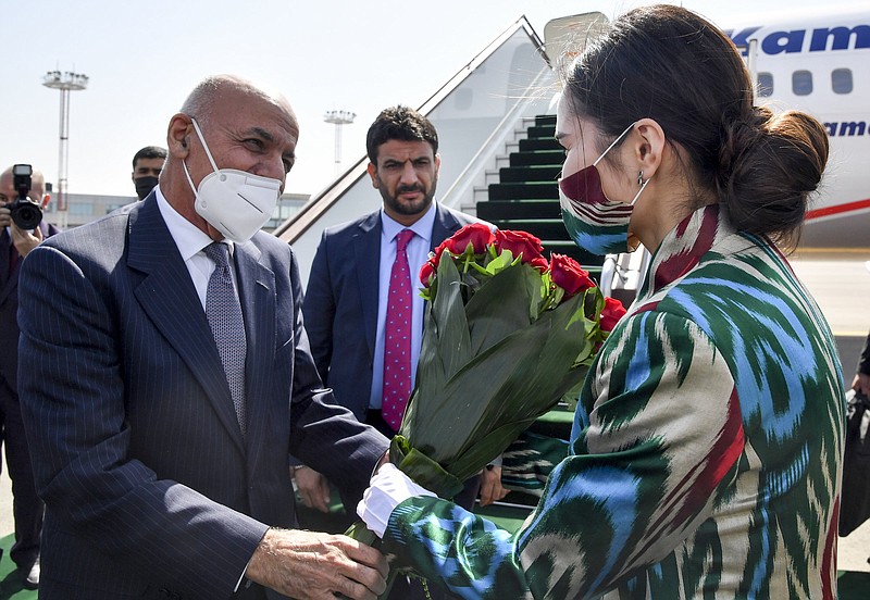 Afghan President Ashraf Ghani receives flowers Thursday upon his arrival at Tashkent International Airport in Uzbekistan to attend a regional meeting.
(AP)