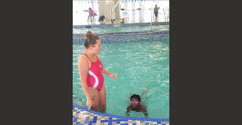 A Pine Bluff Aquatics Center coach teaches Friendship third-grader Lauren Davis swimming basics during a recent lesson. 
(Special to The Commercial/Friendship Aspire Academy)