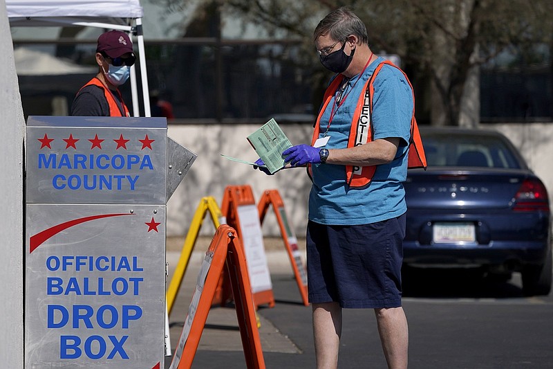 Volunteers help voters drop off their ballots Oct. 20 at the Maricopa County Recorder’s Office in Phoenix.
(AP/Ross D. Franklin, File)