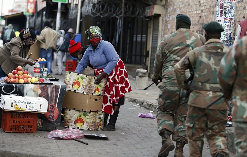 South African Defence Force soldiers, deployed by  the army to assist police in quelling the weeklong riots and violence sparked by the imprisonment of former President Jacob Zuma, patrol the streets Thursday in Alexandra Township, north of Johannesburg.
(AP)