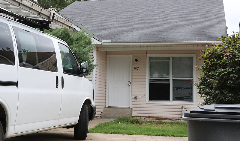 A van is parked outside 107 Rocky Reef Circle Friday morning, where the bodies of a man and woman were discovered by police. (Hot Springs Sentinel-Record/Richard Rasmussen)