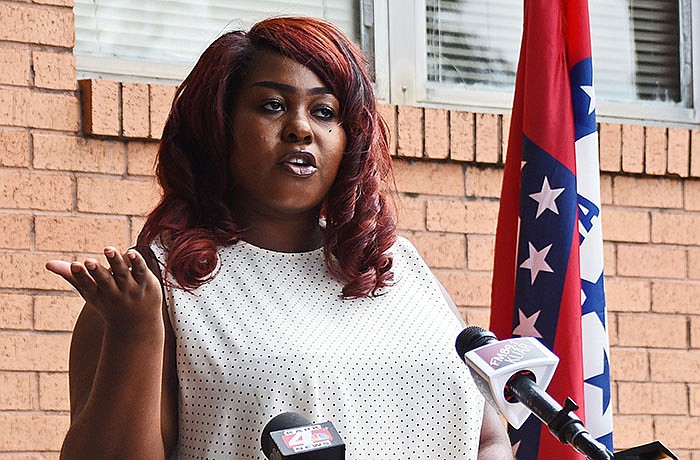 CaSandra Glover of Searcy, a single mother who recently earned a master’s degree in social work, talks about how the Child Tax Credit relief payments will help her and her son during a news conference Thursday at the Democratic Party of Arkansas headquarters in Little Rock.
(Arkansas Democrat-Gazette/Staci Vandagriff)