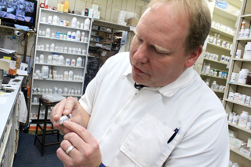 Daniel Lunsford, owner of Prince Drug Store in Fort Smith, shows a capsule of the Johnson & Johnson covid-19 vaccine Thursday at his pharmacy.
(NWA Arkansas Democrat-Gazette/Max Bryan)