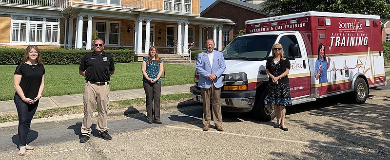 SouthArk school officials pose in front of the school’s new ambulance trainer vehicle. From left to right are Columbia County Ambulance Service owner Amanda Warren-Newton; SouthArk emergency medical services program director Justin Murphree; SouthArk academic affairs vice president Dr. Stephanie Tully-Dartez; SouthArk president Dr. Bentley Wallace; and SouthArk health sciences dean Caroline Hammond. (contributed)