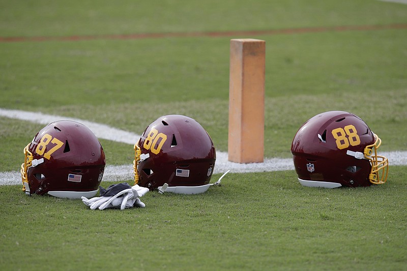 Washington Football Team helmets are on the field during an NFL football OTA at Inova Sports Performance Center in Ashburn, Va. Washington’s NFL team will not be called the Warriors or have any other Native American imagery in the new name when it’s revealed next year. (AP Photo/Luis M. Alvarez, File)