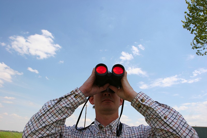 In this 2005 file photo, Kevin Pierson identifies a bird through his binoculars on Wetland Reserve Program land along the Arkansas River near Woodson. (Arkansas Democrat-Gazette/STEPHEN B. THORNTON)