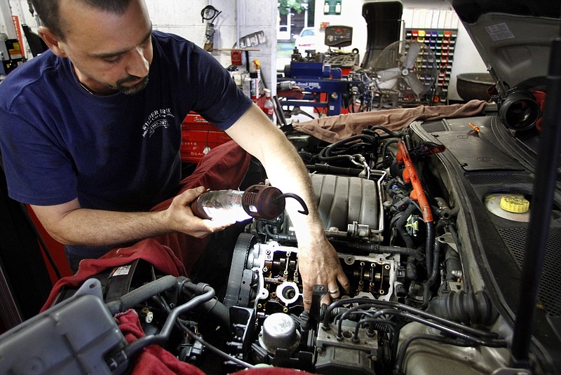 Andre Monteiro works on a vehicle at Wilder Brothers American Car Care Center in Scituate, Mass. Independent repair shops like Wilder’s have been pushing to lift restrictions that block access to computer codes needed to repair cars.
(AP)