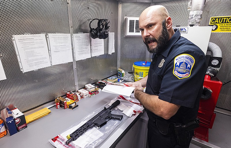 District of Columbia police detective Wayne Garrish inside the Bureau of Alcohol, Tobacco, Firearms and Explosives mobile command center Thursday in Washington displays a privately made AR-15-style weapon confiscated after a crime. Deputy Attorney General Lisa Monaco toured the center after she and Attorney General Merrick Garland announced a crackdown on illegal gun trafficking.
(AP/Jim Lo Scalzo)