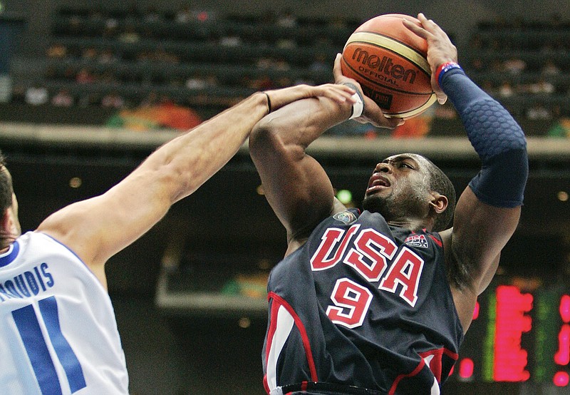 n this Sept. 1, 2006, file photo, USA’s Dwyane Wade (9), right, is fouled by Greece’s Dimos Dikoudis during the semifinals of the World Basketball Championships in Saitama, Japan. The 2006 world championship was perhaps the last truly wide-open international basketball event. Argentina arrived as the Olympic champion and Spain left as the world champion, the last time for a long while anyone other than the U.S. would hold either title.