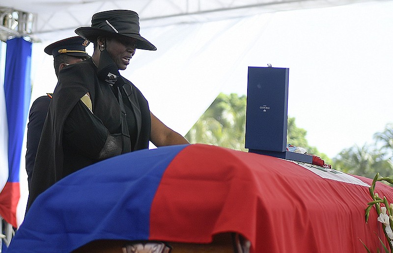 Martine Moise, widow of President Jovenel Moise of Haiti, grieves at his casket Friday during his funeral in Cap-Haitien. The former first lady, who was injured in the July 7 assassination of Moise, told the gathering that her family was “living in dark days” and suggested her husband had been killed by the country’s leading bourgeoisie families.
(AP/Matias Delacroix)
