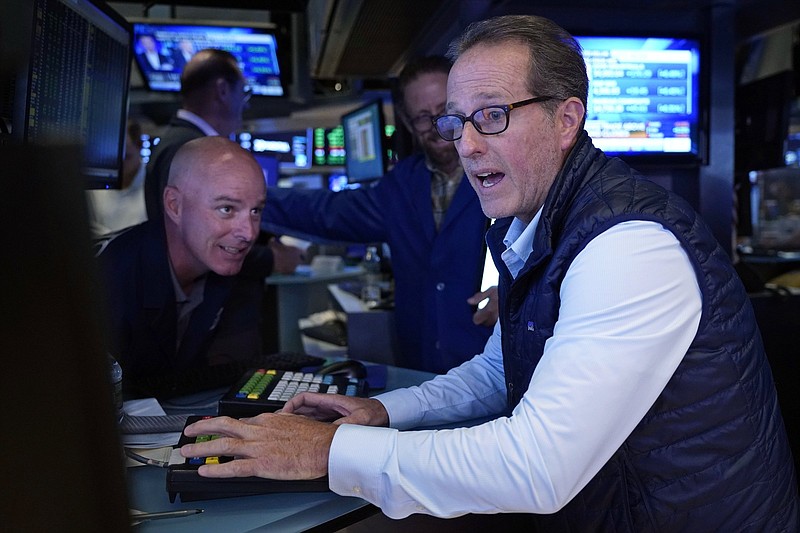 Specialists John O’Hara (left) and Glenn Carell work Friday on the floor of the New York Stock Exchange.
(AP/Richard Drew)