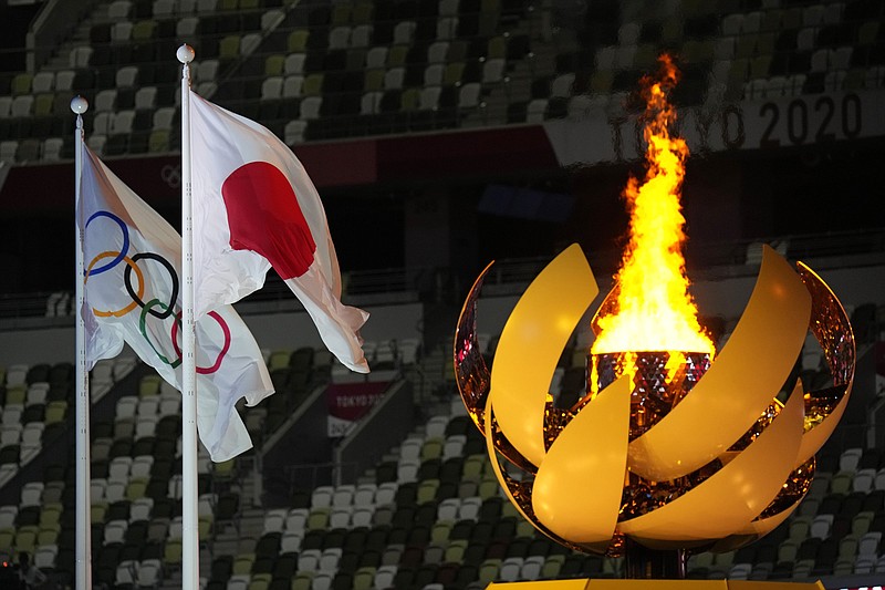 The Olympic flame burns at the end of Friday’s opening ceremony of the summer Olympic Games in Tokyo. Japanese tennis star Naomi Osaka lit the cauldron. Athletes from 209 nations are slated to compete in the Games. More photos available at arkansasonline.com/724tokyo21.
(AP/Petr David Josek)