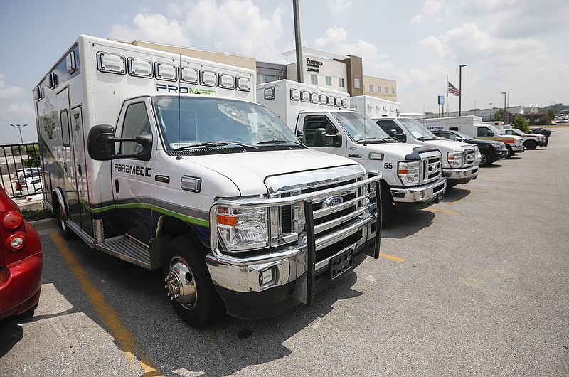 Ambulances sit ready Friday at the Doubletree Hotel in Springfield, Mo. The ambulances are with a medical team called to Springfield to help transport rising numbers of covid-19 patients.
(AP/The Springfield News-Leader/Andrew Jansen)