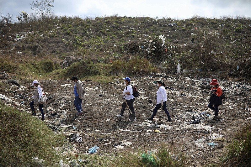 People seeking their missing loved ones look for signs of clandestine graves at a municipal dump in Veracruz, Mexico, in March 2019 after an anonymous source sent the group a map suggesting hundreds of bodies were buried in the area.
(AP/Felix Marquez)