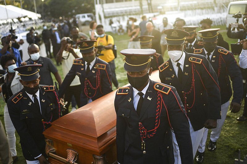 Police carry the coffin of slain Haitian President Jovenel Moise at the start of the funeral at his family home in Cap-Haitien, Haiti, early Friday, July 23, 2021. (AP/Matias Delacroix)