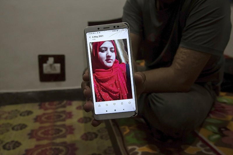 Shahid Nazir Bhat, a Muslim, displays a photograph of Manmeet Kour Bali, a Sikh by birth who converted to Islam to marry him, in Srinagar, India. New laws across India, in states ruled by Prime Minister Narendra Modi’s Bharatiya Janata Party, are seeking to ban all interfaith marriages.
(The New York Times/Showkat Nanda)