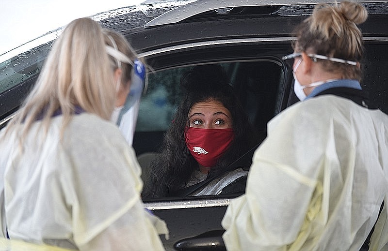 Karson Freeman of Little Rock prepares to undergo coronavirus testing at a drive-thru clinic across from Baum-Walker Stadium on the outskirts of the University of Arkansas, Fayetteville campus in this Sept. 1, 2020, file photo. (NWA Democrat-Gazette/David Gottschalk)