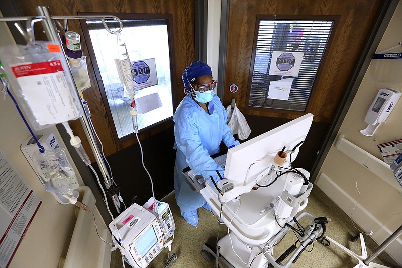 Nurse Takela Gardner looks over a patient's chart before entering a room in one of the Covid wards at University of Arkansas for Medical Science on Thursday, July 22, 2021, in Little Rock. .More photos at www.arkansasonline.com/725covid/.(Arkansas Democrat-Gazette/Thomas Metthe)