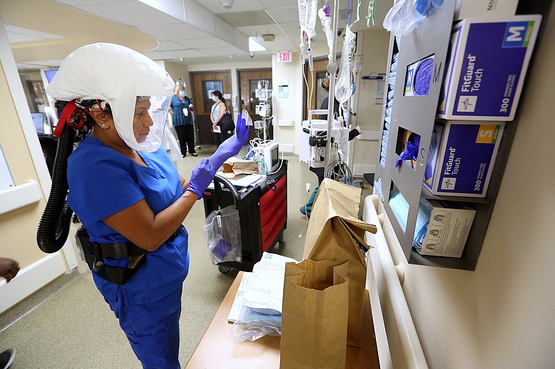 Nurse practitioner Naomi Crume, with the vascular access team, gets her equipment ready in the hallway of one of the Covid wards at University of Arkansas for Medical Science on Thursday, July 22, 2021, in Little Rock. .(Arkansas Democrat-Gazette/Thomas Metthe)