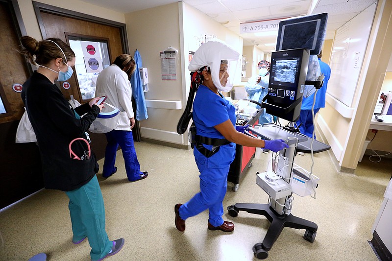 Nurse practitioner Naomi Crume, with the vascular access team, gets her equipment ready in the hallway of one of the Covid wards at University of Arkansas for Medical Science on Thursday, July 22, 2021, in Little Rock. .(Arkansas Democrat-Gazette/Thomas Metthe)