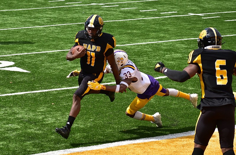 Skyler Perry, quarterback for the University of Arkansas at Pine Bluff, rushes for a touchdown at Simmons Bank Field in Pine Bluff in this April 17, 2021, file photo. Perry broke a tackle from Prairie View free safety Tariq Mulmore. (Pine Bluff Commercial/I.C. Murrell)