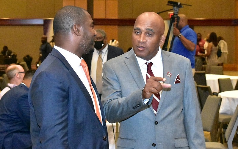 Alabama A&M Coach Connell Maynor (right) talks to Florida A&M Coach Willie Simmons on Tuesday before the SWAC Media Day in Birmingham, Ala. 
(Pine Bluff Commercial/I.C. Murrell)