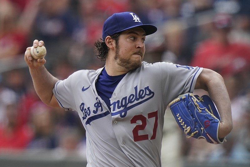 FILE - In this June 6, 2021, file photo, Los Angeles Dodgers starting pitcher Trevor Bauer delivers in the first inning of a baseball game against the Atlanta Braves in Atlanta. Bauer appeared in court Friday, July 23, 2021, to fight the extension of a protective order sought by a woman who says he choked her to the point where she lost consciousness and punched her during two sexual encounters earlier this year. (AP Photo/Brynn Anderson, File)