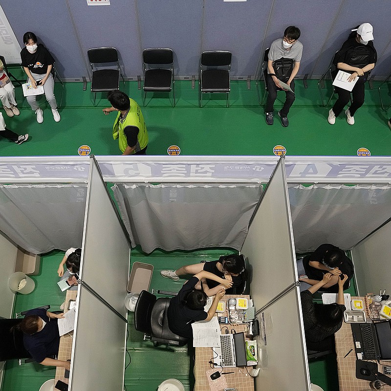 People receive a first dose of the Pfizer covid-19 vaccine Wednesday at a vaccination center in Seoul, South Korea. Officials reported a new daily high for coronavirus cases, a day after authorities enforced stringent restrictions in areas outside the capital.
(AP/Ahn Young-joon)