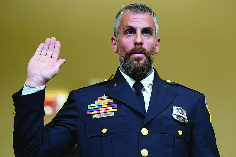 Washington Metropolitan Police Department officer Michael Fanone is sworn in to testify to the House select committee hearing on the Jan. 6 attack on Capitol Hill in Washington, Tuesday, July 27, 2021. (AP Photo/ Andrew Harnik, Pool)