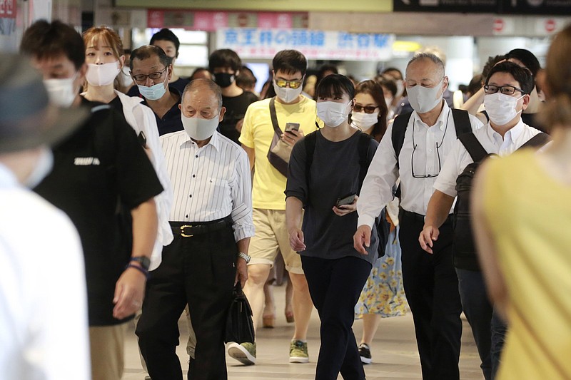 People walk at a train station Wednesday in Tokyo, where a rise in covid-19 cases prompted the governor to plead for young people to get vaccinated.
(AP/Koji Sasahara)