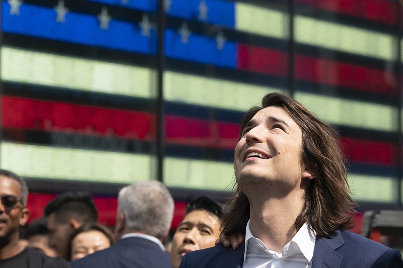 Vladimir Tenev, chief executive officer and co-founder of Robinhood, celebrates Thursday in New  York’s Times Square after his company’s initial public stock offering.
(AP/Mark Lennihan)