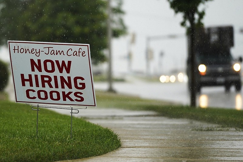 A sign in Downers Grove, Ill., calls for applicants for job openings in this file photo from June. The number of Americans collecting unemployment benefits slid last week, another sign that the job market is recovering.
(AP)