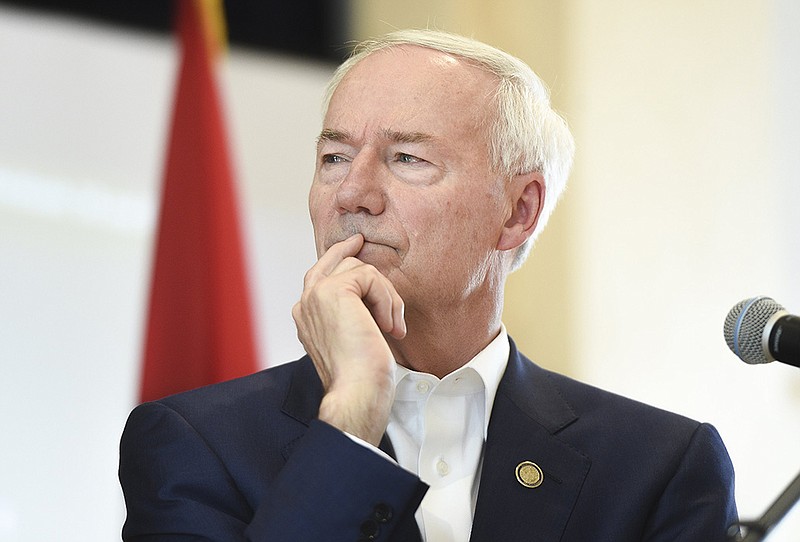 Gov. Asa Hutchinson listens to Secretary of Health Jose Romero as he speaks at the American Legion Community Hall in Siloam Springs on Friday, July 30, 2021. More photos at arkansasonline.com/731governor/. (NWA Democrat-Gazette/Charlie Kaijo)