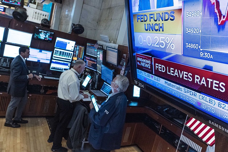 A screen in a booth on the floor of the New York Stock Exchange shows Wednesday’s interest-rate decision by the Federal Reserve. Inflation is rising faster than predicted by some policymakers, a sign of the bumpiness of the economic recovery.
(AP/Richard Drew)